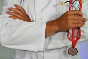 Chronic disease healthcare professional holding a stethoscope, symbolising medical care for frailty and ethnicity health disparities.